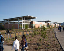The prefab classroom components contrast with the site-built screened studios under hovering metal roofs seen in this photo. - Photo Credit: Jim Brady Architectural Photography