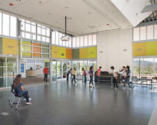 The main commons, pictured in this photo, is surrounded with polycarbonate glazing on all four sides to provide a gathering space bathed in controlled daylight. - Photo Credit: Jim Brady Architectural Photography