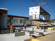 The prefab components (shown in this photo on the factory floor) utilize a steel moment frame with light-gauge steel stud infill, metal deck floors and metal deck roofs. All are high in recycled content and are recyclable and demountable materials. - Photo Credit: Christopher Gerber