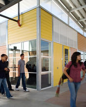 As seen in this photo, the steel moment frames of the modular components allows glazing to wrap corners (important in a school that values transparency and openness) and for broad polycarbonate transom panels to be placed wherever necessary. - Photo Credit: Jim Brady Architectural Photography